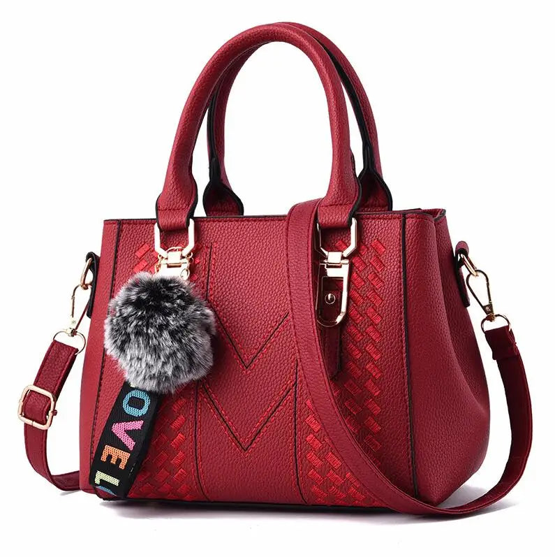Bolso bandolera mujer – cuero con bordado y detalle de pompón