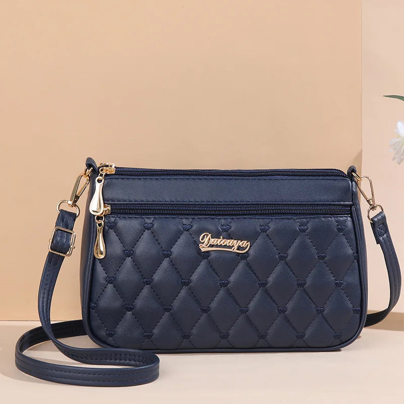 Bolso bandolera mujer – cuero con bordado y detalle de pompón